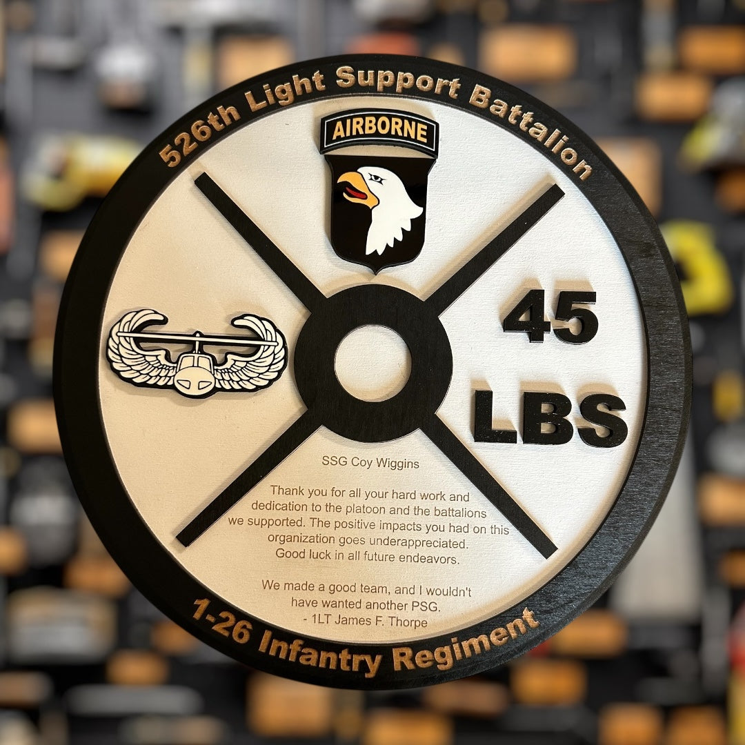 Weight plate military gift with 526th Light Support Battalion and airborne logo on a blurred background