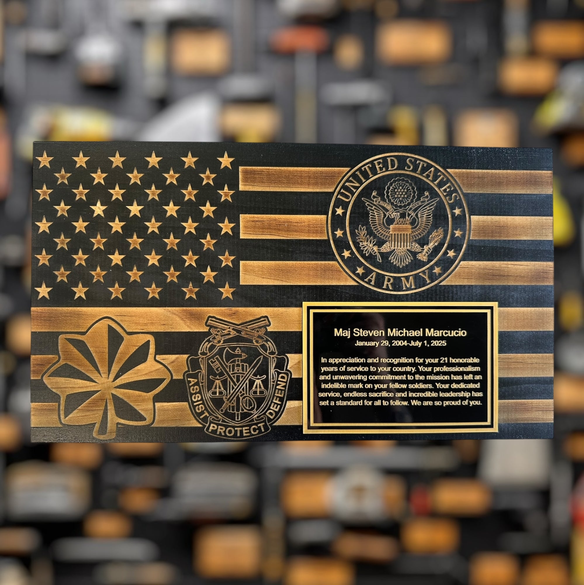 United States Army flag military gift with engraved unit logos and rank with text on a blurred background