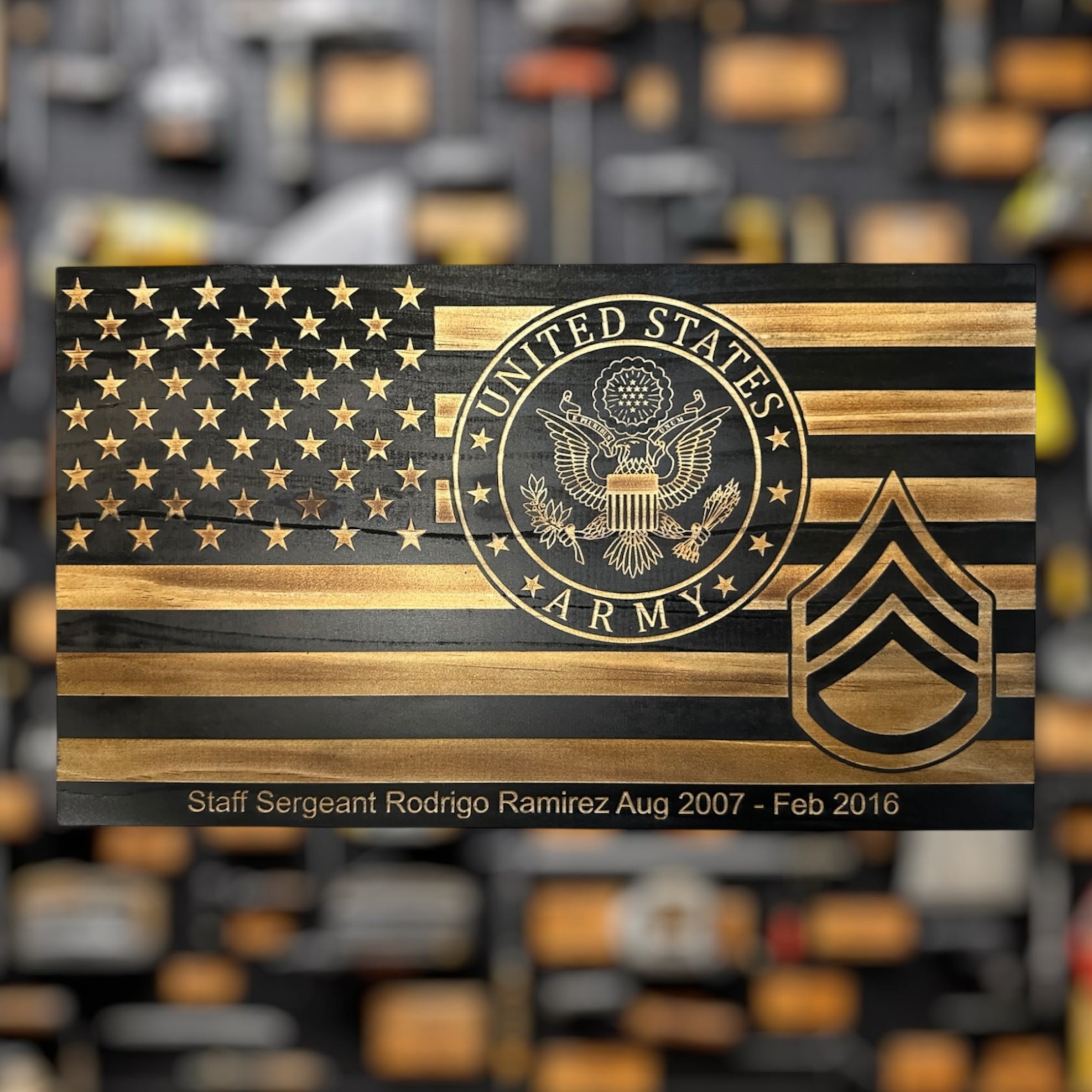 Wooden plaque military gift  with U.S. Army emblem Staff Sergeant Rank and American flag design on a blurred background