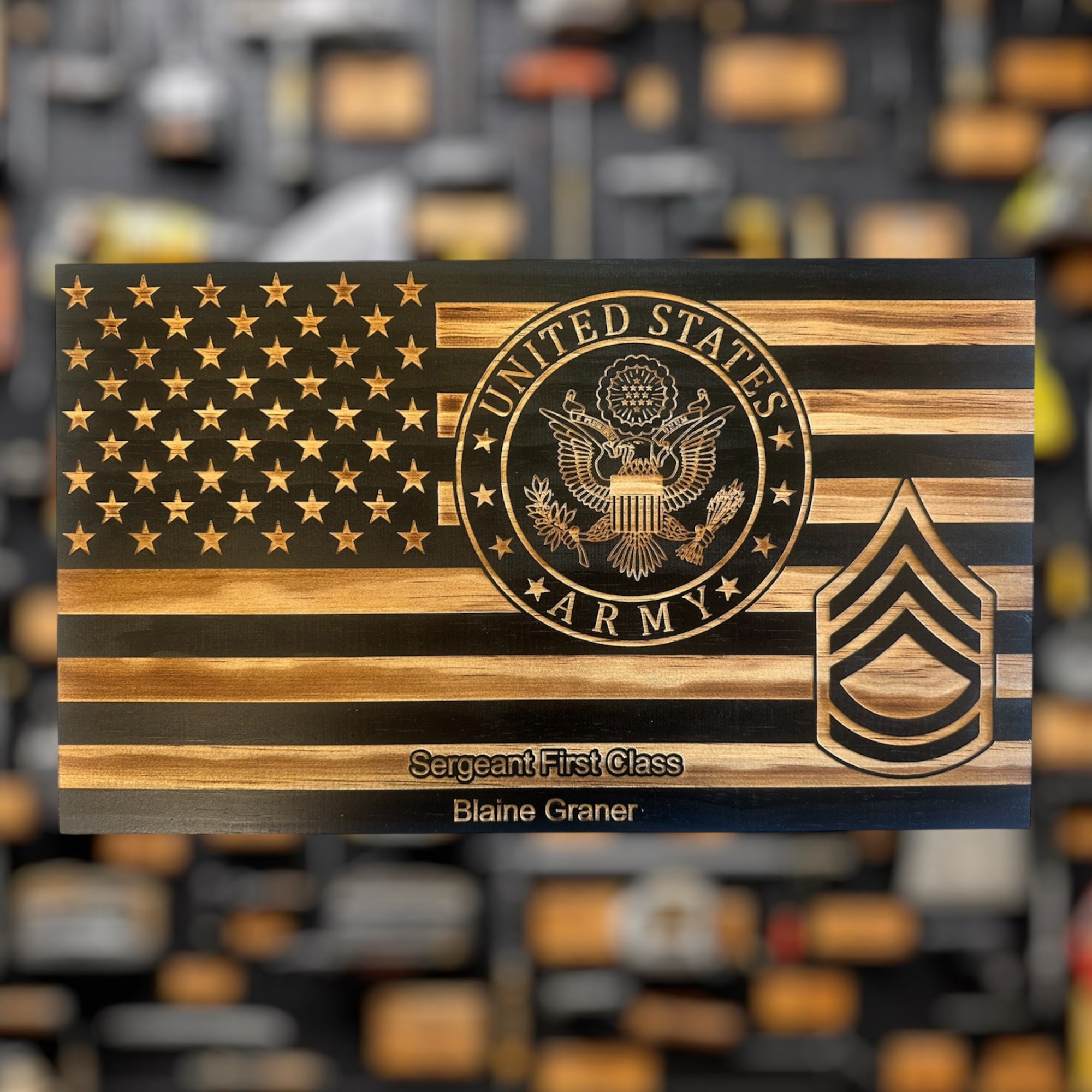Wooden plaque military gift with U.S. Army emblem and 'Sergeant First Class' insignia on a blurred background