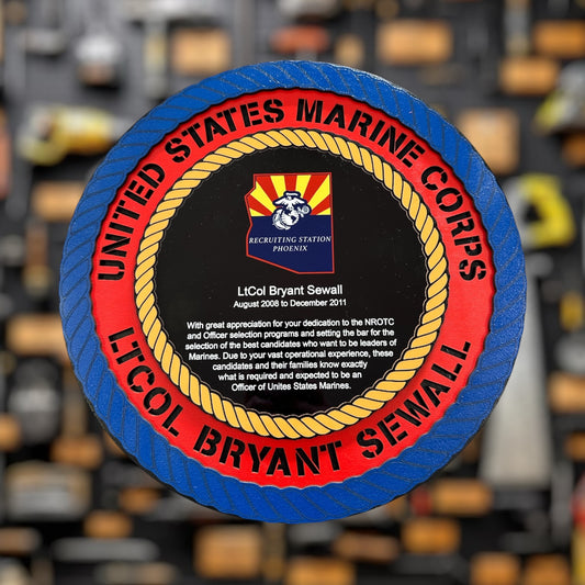 United States Marine Corps recruiting plaque with a red and blue border, featuring the name and rank 'LTCOL'  on a blurred background.